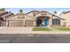 Single-story home with 3-car garage, desert landscaping, and a bright blue front door at 9654 E Pantera Ave, Mesa, AZ 85212