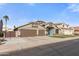 Charming single-story home featuring a 3-car garage, desert landscaping, and a bright blue front door at 9654 E Pantera Ave, Mesa, AZ 85212