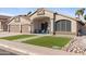 Well maintained property with manicured artificial lawn and covered porch with seating area at 9654 E Pantera Ave, Mesa, AZ 85212