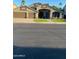 Charming single-story home featuring a three-car garage and landscaped front yard at 9654 E Pantera Ave, Mesa, AZ 85212