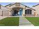 Well maintained property with manicured artificial lawn and covered porch with seating area at 9654 E Pantera Ave, Mesa, AZ 85212