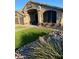 Beautiful home featuring artificial grass, custom rock landscaping, and an inviting front porch at 9654 E Pantera Ave, Mesa, AZ 85212