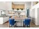 Kitchen with a large island, stainless steel appliances, and stylish blue chairs at 9654 E Pantera Ave, Mesa, AZ 85212