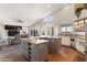 Open-concept kitchen boasts a large island with seating, stainless steel appliances, and natural light at 9654 E Pantera Ave, Mesa, AZ 85212