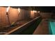Close up of the backyard landscaping featuring tiki torches, river rock, and a synthetic grass border at 9654 E Pantera Ave, Mesa, AZ 85212