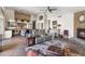 Open concept living room with stone fireplace, kitchen, and slate flooring throughout at 9654 E Pantera Ave, Mesa, AZ 85212