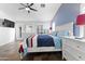 Inviting main bedroom featuring a ceiling fan, closet, and dresser at 9654 E Pantera Ave, Mesa, AZ 85212