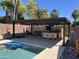 Backyard with a covered outdoor kitchen, a built-in grill and bar, and a sparkling pool at 9654 E Pantera Ave, Mesa, AZ 85212