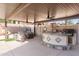 Entertainers backyard featuring a covered outdoor kitchen with a built in grill and bar seating at 9654 E Pantera Ave, Mesa, AZ 85212