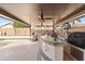 Covered outdoor kitchen featuring a BBQ grill, bar seating, TV, and plenty of counter space at 9654 E Pantera Ave, Mesa, AZ 85212