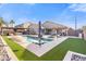 Gorgeous backyard pool with a covered outdoor kitchen, a swim up bar, and plenty of lounge seating at 9654 E Pantera Ave, Mesa, AZ 85212
