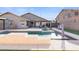 Home exterior featuring a stunning pool with a swim up table and landscaped backyard at 9654 E Pantera Ave, Mesa, AZ 85212