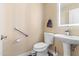 Well-lit powder room with a pedestal sink, modern fixtures, and neutral color palette at 9654 E Pantera Ave, Mesa, AZ 85212