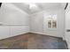 This room features a ceiling fan, wainscoting, and a window with shutters at 9654 E Pantera Ave, Mesa, AZ 85212