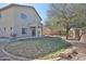 Private backyard with patio area, lawn, and mature trees at 10022 W Luxton Ln, Tolleson, AZ 85353