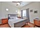 Bedroom features a comfortable bed, side tables, and a window offering natural light for a relaxing atmosphere at 10022 W Luxton Ln, Tolleson, AZ 85353