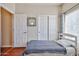 Bedroom features a comfortable bed, closet, and a window offering natural light for a relaxing atmosphere at 10022 W Luxton Ln, Tolleson, AZ 85353
