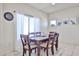 Well-lit dining room features neutral wall colors, tile flooring, and a wooden dining table with seating for six at 10022 W Luxton Ln, Tolleson, AZ 85353