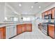 Spacious kitchen with granite countertops, stainless steel appliances, and tile flooring at 10022 W Luxton Ln, Tolleson, AZ 85353
