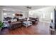 Open-concept living room showcases hardwood floors and seamless flow to the kitchen at 10022 W Luxton Ln, Tolleson, AZ 85353