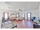 Large living room area with hardwood floors, comfortable seating, and a ceiling fan at 10022 W Luxton Ln, Tolleson, AZ 85353