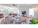 Bright living room boasts hardwood floors, vaulted ceilings, and ample seating at 10022 W Luxton Ln, Tolleson, AZ 85353