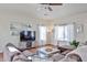 Inviting living room with hardwood floors, comfortable seating, and a ceiling fan at 10022 W Luxton Ln, Tolleson, AZ 85353