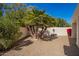 Backyard features a mature palm tree and gravel ground cover at 10056 E San Bernardo Dr, Scottsdale, AZ 85258