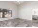 Bright bedroom with gray tiled floors leads to a bathroom, with a large window offering lots of natural light at 10056 E San Bernardo Dr, Scottsdale, AZ 85258