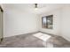 Bright bedroom with a ceiling fan, large window with sunlit gray tile floors at 10056 E San Bernardo Dr, Scottsdale, AZ 85258