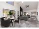 Open-concept dining and living area with vaulted ceilings, large windows, and contemporary decor at 10056 E San Bernardo Dr, Scottsdale, AZ 85258