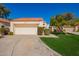 Charming home featuring a two-car garage, manicured lawn, and well-maintained landscaping at 10056 E San Bernardo Dr, Scottsdale, AZ 85258
