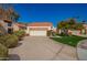 Charming single-story home featuring a tile roof, a two-car garage and a well-manicured front yard at 10056 E San Bernardo Dr, Scottsdale, AZ 85258