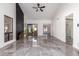 Open-concept living room with a large windows and sleek, modern tile flooring at 10056 E San Bernardo Dr, Scottsdale, AZ 85258