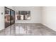 Bright living room with gray-tiled floor, large window, and sliding glass door creates a modern and airy feel at 10056 E San Bernardo Dr, Scottsdale, AZ 85258
