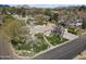 Wide aerial shot of a home with extensive grounds, showcasing the lawn, driveway, trees, and surrounding neighborhood at 1018 W Kaler Dr, Phoenix, AZ 85021