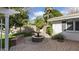 Charming backyard with a brick patio, water fountain feature, and mature trees at 1018 W Kaler Dr, Phoenix, AZ 85021