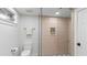 Modern bathroom with a glass-enclosed shower, tiled walls, and a sleek toilet at 1018 W Kaler Dr, Phoenix, AZ 85021