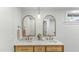 Bathroom featuring a double sink vanity with gold hardware and a stylish light fixture at 1018 W Kaler Dr, Phoenix, AZ 85021