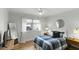Stylish bedroom with modern decor, including a wooden nightstand, window, and large mirror at 1018 W Kaler Dr, Phoenix, AZ 85021