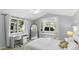 Bright bedroom with a built-in window seat, white desk, and vaulted ceiling at 1018 W Kaler Dr, Phoenix, AZ 85021