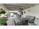Inviting outdoor patio with comfortable seating, ceiling fan, outdoor kitchen, and a brick fire pit at 1018 W Kaler Dr, Phoenix, AZ 85021