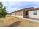 Backyard view featuring the enclosed patio and a well maintained lawn at 10960 E Monte Ave # 257, Mesa, AZ 85209