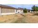 Exterior rear view of home showcasing enclosed patios and manicured lawn at 10960 E Monte Ave # 257, Mesa, AZ 85209