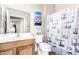 Cozy bathroom with wood vanity and a stylish shower curtain at 10960 E Monte Ave # 257, Mesa, AZ 85209