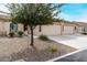 Cozy one-story home featuring a well-kept desert front yard and a two-car garage at 10960 E Monte Ave # 257, Mesa, AZ 85209