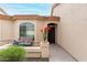 Inviting front porch with potted plants, a cozy bench, and a welcoming entrance at 10960 E Monte Ave # 257, Mesa, AZ 85209