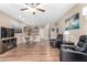 Open-concept living space with hardwood floors, ceiling fan, and access to the kitchen at 10960 E Monte Ave # 257, Mesa, AZ 85209