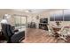 Inviting living and dining area with hardwood floors, entertainment center, and sliding doors at 10960 E Monte Ave # 257, Mesa, AZ 85209