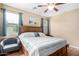 Cozy bedroom featuring a ceiling fan, natural light, and seating area at 10960 E Monte Ave # 257, Mesa, AZ 85209